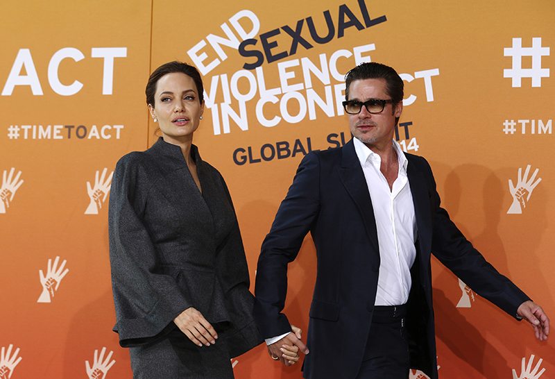 Angelina Jolie and Brad Pitt arrive at a summit to end sexual violence in conflict, in London