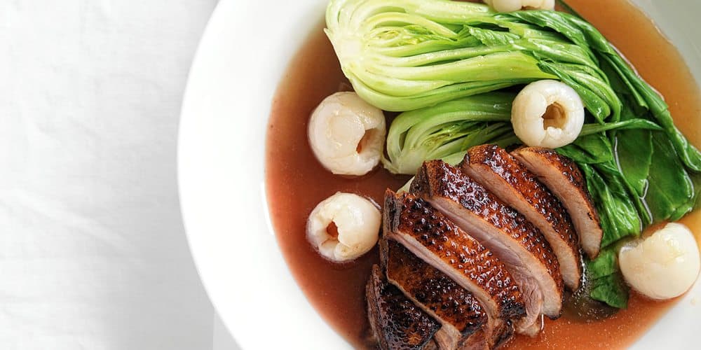 Chinese-Style Roasted Duck served with Lychees and Bok Choy