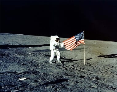 Charles "Pete" Conrad Jr. stands with the American flag on the lunar surface during the Apollo 12 mission in 1969.. REUTERS/NASA NASA
