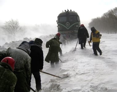 Rescuers shovel snow from a railroad to make way for a stranded train in Inner Mongolia Autonomous Region.. Reuters