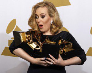 Adele holds her six Grammy Awards