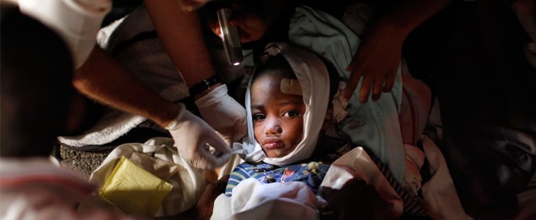A injured child receives medical treatment after an earthquake in Port-au-Prince January 13, 2010.. REUTERS/Eduardo Munoz