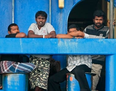 Sri Lankan refugees look out from the Australian coast guard vessel Oceanic Viking anchored near Tamborah Laut, about 14km (8.2 miles) east of Tanjung Pinang and the port of Kijang on the Indonesian island of Bintan.. REUTERS/Vivek Prakash