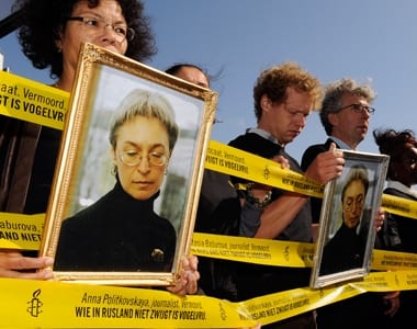Protesters hold pictures of murdered Russian journalist Anna Politkovskaya during a demonstration against the visit of Russia's President Dmitry Medvedev in Amsterdam. Politkovskaya was shot dead in 2006 by an assassin in her apartment block.. REUTERS/Toussaint Kluiters/United Photos