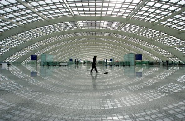 A worker cleans the floor in the Ground Transportation Center (GTC), connecting the Beijing airport light rail line, in the new terminal building T3 (Terminal Three) at the Beijing Capital International Airport on February 1, 2008 in Beijing, China. T3 is reported as the largest and most advanced airport terminal in China and will have an initial capacity of 35 million annual passengers. The project is completed and scheduled to be trial operated on  Febuary 29.. China Photo/Getty Images