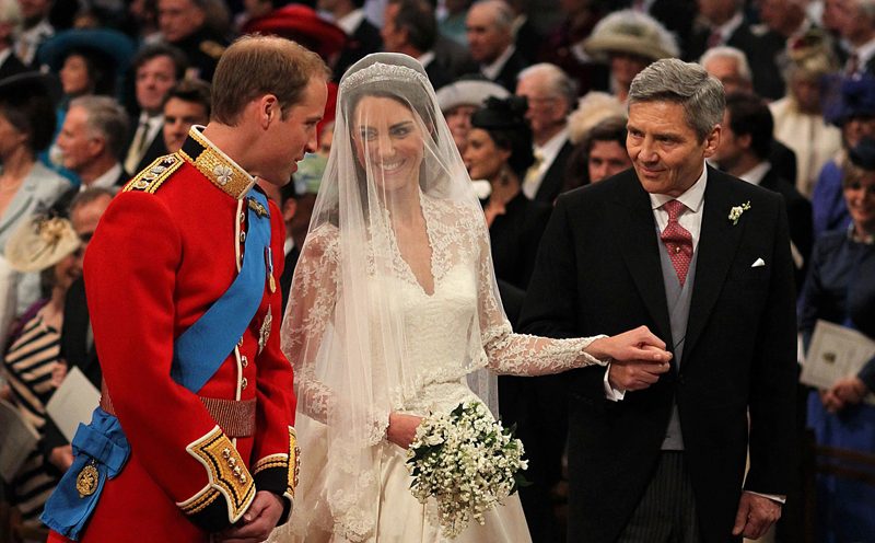 Britain's Prince William stands at the altar with his bride, Kate Middleton, and her father Michael, during their wedding at Westminster Abbey in central London. REUTERS/POOL New