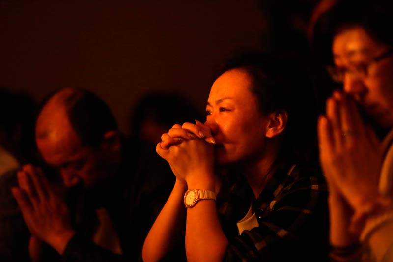 Relatives of passengers onboard Malaysia Airlines Flight MH370 pray at a praying room at Lido Hotel in Beijing March 24, 2014. A Chinese military aircraft searching for the missing aircraft spotted several "suspicious" floating objects on Monday in remote seas off Australia, increasing the likelihood that the wreckage of the plane may soon be found.  REUTERS/Jason Lee