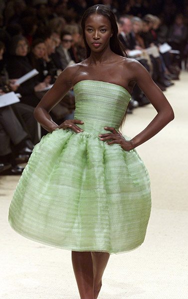 British top model Naomi Campbell presents this pale green cocktail dress as part of French fashion house Balmain's Spring-Summer 1999 Haute Couture fashion collection designed by Oscar de la Renta.