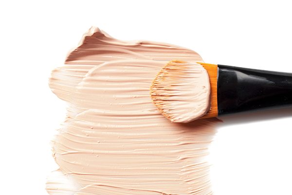 professional brush and foundation sample on white