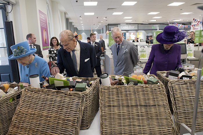 The Queen, Prince Philip, Prince Charles and Camilla look at food hampers during a visit to a supermarket in Poundbury yesterday. Picture: Reuters