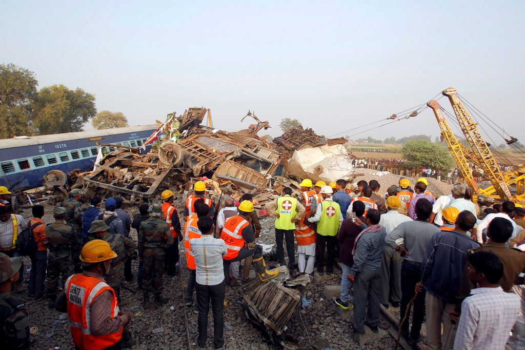 Rescue workers search for survivors at the site of a train derailment in Pukhrayan, south of Kanpur city, India. REUTERS/Jitendra Prakash - RTSSGZD