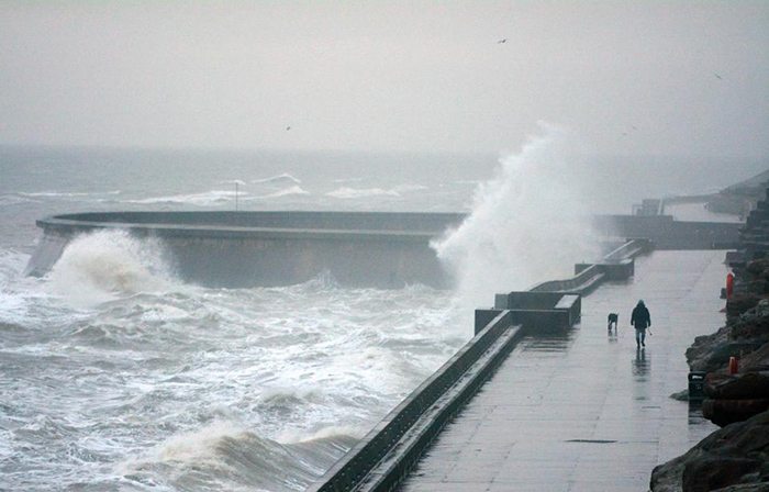 With massive tides about to hit Britain's sea walls, the Environment Agency warned photographers and thrill-seekers not to go to the coast.