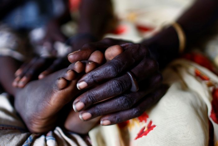 Nyagonga Machul, 38, touches the feet of her younger daughter, Nyawan Mario, 4, in their home at the United Nations Mission in South Sudan (UNMISS) Protection of Civilian site (CoP) in Juba, South Sudan, February 15, 2017. REUTERS/Siegfried Modola 