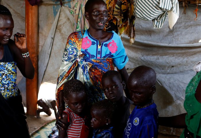 Nyagonga Machul, 38, embraces her children (L-R) Nyameer Mario, 6, Nyawan Mario, 4, Ruai Mario, 10, and Machiey Mario, 8, after being reunited with them at the United Nations Mission in South Sudan (UNMISS) Protection of Civilian site (CoP) in Juba, South Sudan, February 13, 2017. REUTERS/Siegfried Modola 