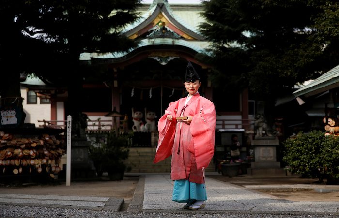 Shinto priest Tomoe Ichino, 40, poses for a photograph at the Imado Shrine in Tokyo, Japan, February 22, 2017. "In general, people think being a Shinto priest is a man's profession. If you're a woman, they think you're a shrine maiden, or a supplementary priestess. People don't know women Shinto priests exist, so they think we can't perform rituals. Once, after I finished performing jiichinsai (ground-breaking ceremony), I was asked, 'So, when is the priest coming?'," Ichino said. "When I first began working as a Shinto priest, because I was young and female, some people felt the blessing was different. They thought: 'I would have preferred your grandfather.' At first, I wore my grandfather's light green garment because I thought it's better to look like a man. But after a while I decided to be proud of the fact that I am a female priest and I began wearing a pink robe, like today. I thought I can be more confident if I stop thinking too much (about my gender)." REUTERS/Toru Hanai