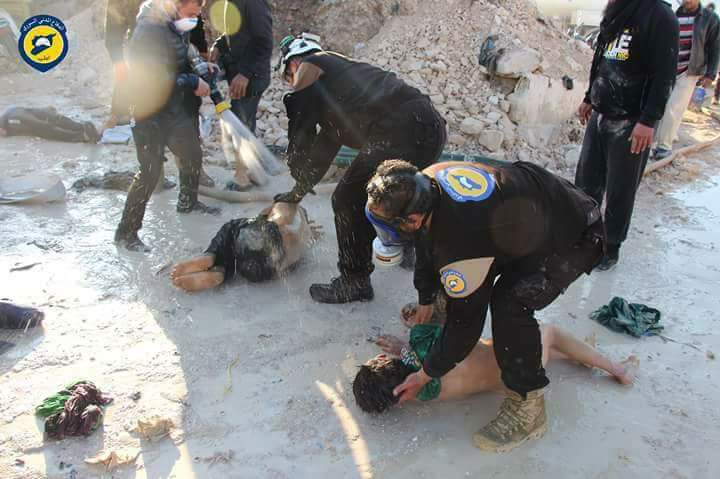 First responders attempt to treat children in yesterday's Syrian gas attack