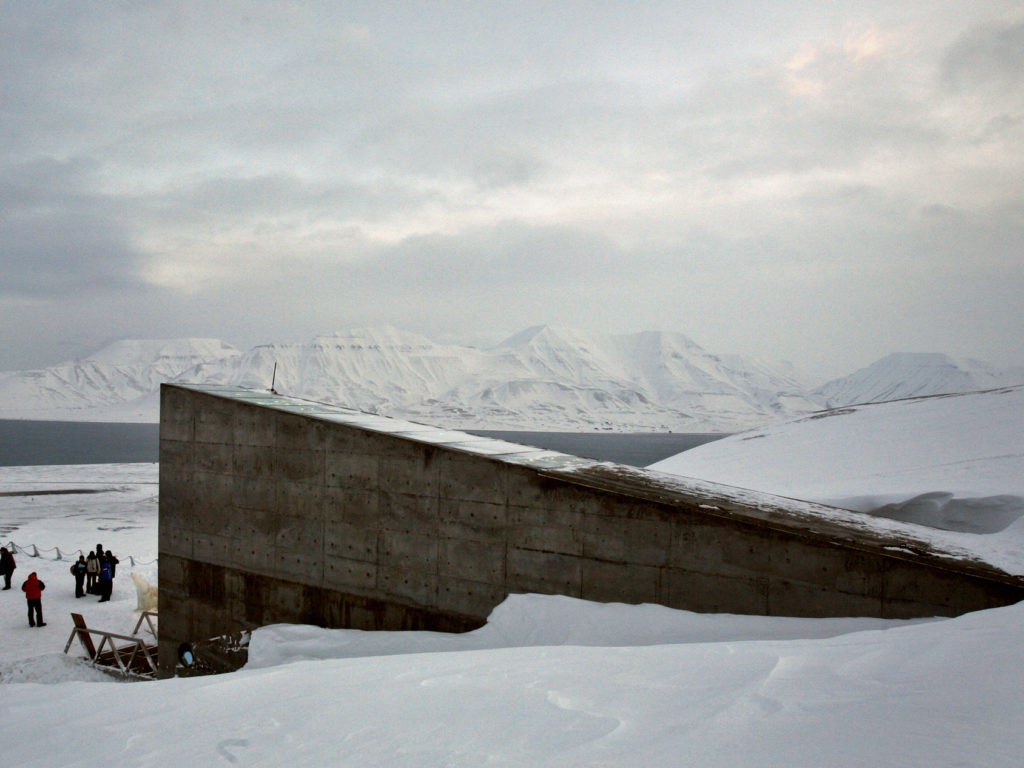 Journalists gather near the entrance to the Global Seed Vault in Longyearbyen February 25, 2008. The vault has been built in a mountainside cavern on Spitsbergen Island around 1,000 km (600 miles) from the North Pole to store the world's crop seeds in case of disaster. The official opening will take place February 26.   REUTERS/Bob Strong (NORWAY) - RTR1XK1N
