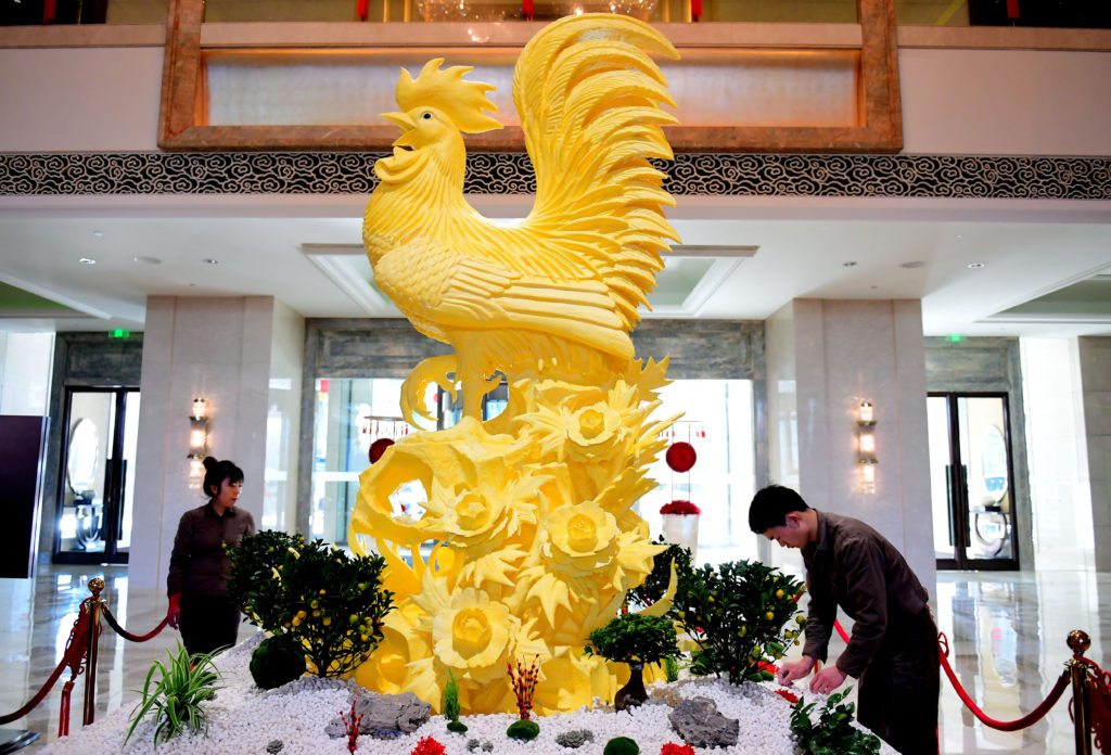 3.6-meter-tall butter rooster is displayed at the hall of a hotel  in Shenyang, Liaoning Province of China. A hotel in Shenyang used 150 kg butter make a 3.6-meter-tall rooster sculpture to welcome the Year of Rooster.  (Photo by VCG/VCG via Getty Images)