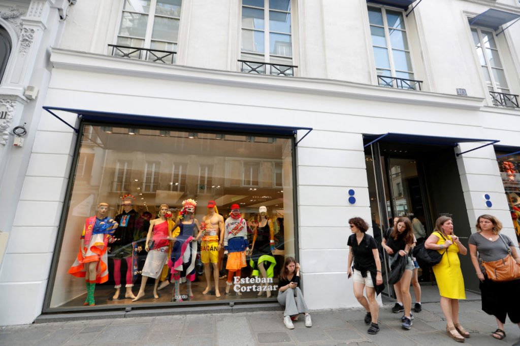 People stand in front of the shop Colette, one of the French capital's trendiest fashion stores, in Paris, France, July 12, 2017 which will close its doors in December after 20 years, with its founder set to retire. REUTERS/Charles Platiau - RTX3B6NT