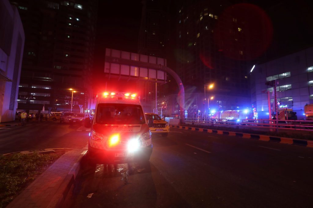Dubai Emergency Response teams and Dubai police are seen on the street near Dubai's Torch tower residential building in the Marina district, Dubai, United Arab Emirates, early hours of August 4, 2017. REUTERS/Hamad I Mohammed 