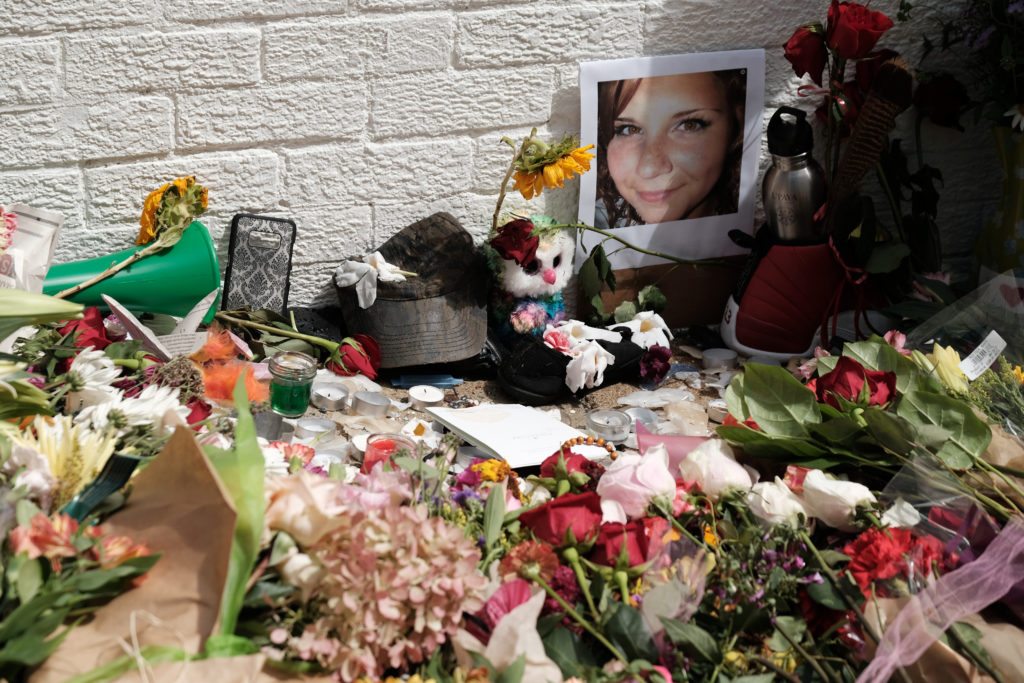 Flowers and a photo of car ramming victim Heather Heyer lie at a makeshift memoriall in Charlottesville, Virginia,  August 13, 2017. REUTERS/Justin Ide