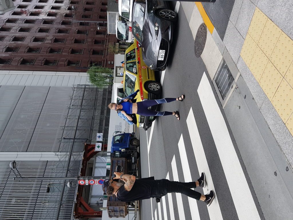 Photographer Steve Visneau shoots on a busy pedestrian crossing in Ginza district.