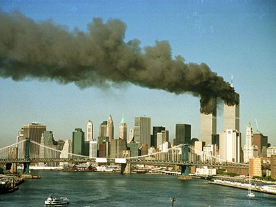 The towers of the World Trade Center billow smoke after being
struck by hijacked commercial airplanes in New York. Taken on September 11, 2001.