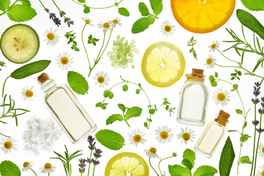 Fresh herbs,fruits and essential oil on white background