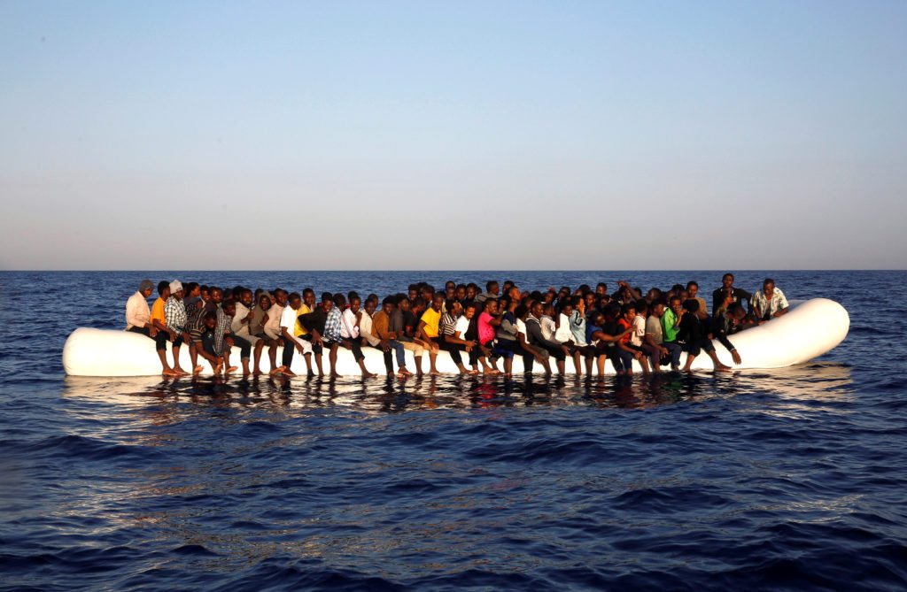 A dinghy overcrowded by African migrants drifts off the Libyan coast in the Mediterranean Sea.