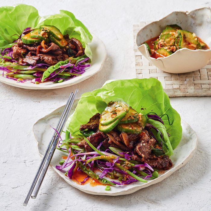 Image of Korean Bulgogi Beef Lettuce Cups topped with Cucumber Kimchi.