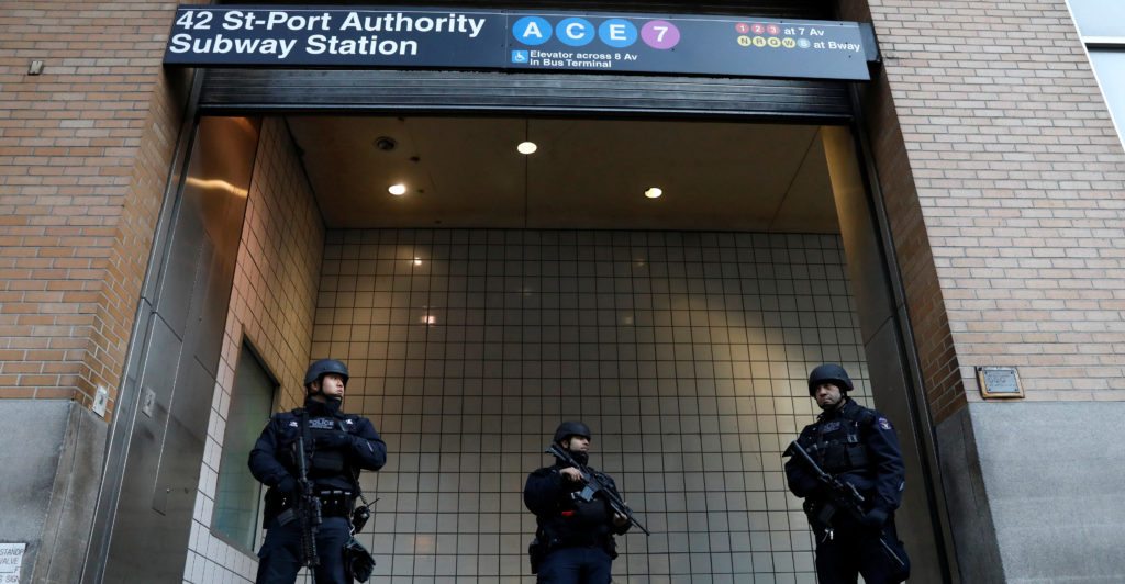 Police officers stand guard outside the closed New York Port Authority Subway entrance following an reported explosion, in New York City, U.S. December 11, 2017. REUTERS/Brendan McDermid - RC1D6B37BF40