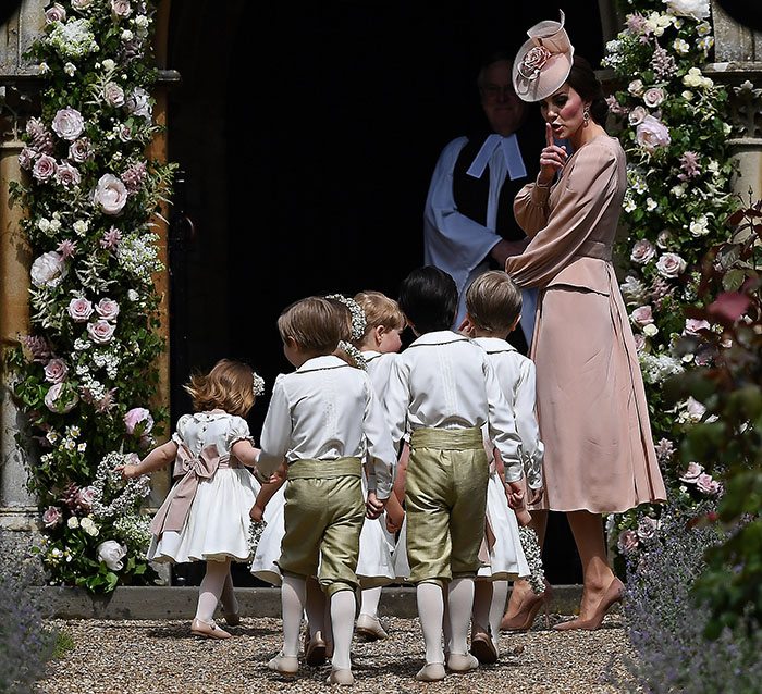 Britain's Catherine, Duchess of Cambridge quietens the pageboys and flower girls at the wedding of Pippa Middleton and James Matthews at St Mark's Church in Englefield, May 20, 2017.    