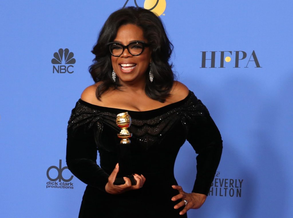 Oprah Winfrey poses backstage at the 75th Golden Globe Awards with her Cecil B. DeMille Award. 