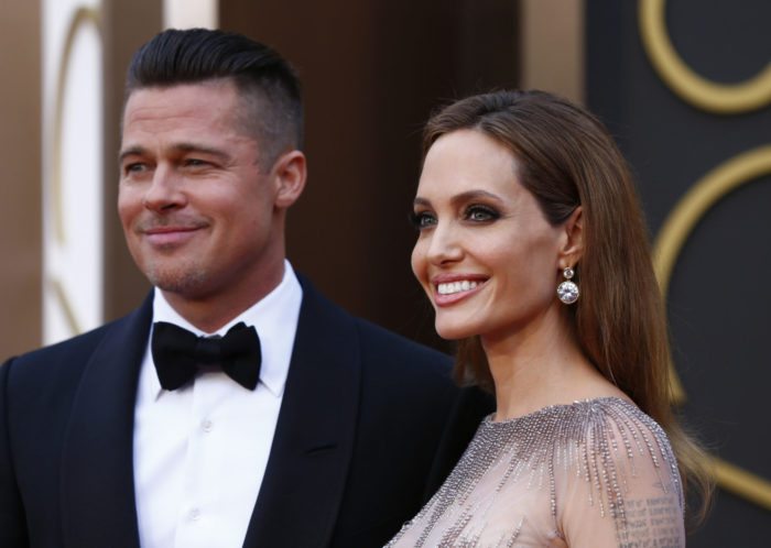 Actor Brad Pitt and his partner, actress Angelina Jolie arrive at the 86th Academy Awards in Hollywood, California March 2, 2014.  REUTERS/Lucas Jackson (UNITED STATES  - Tags: ENTERTAINMENT)(OSCARS-ARRIVALS) - TB3EA330873M5