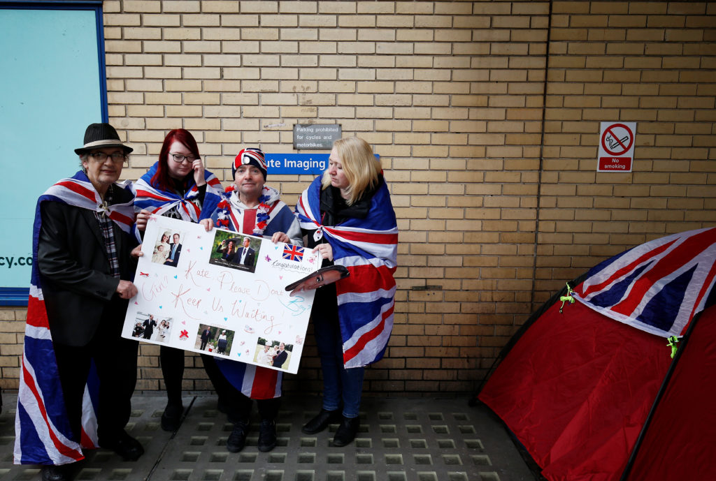 Fans of Britain's royal family stand outside the hospital where the Duchess of Cambridge is due to give birth, in London. REUTERS/Henry Nicholls 