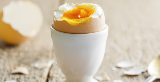Perfect soft boiled egg on a table. Traditional food for healthy breakfast. Close-up shot.