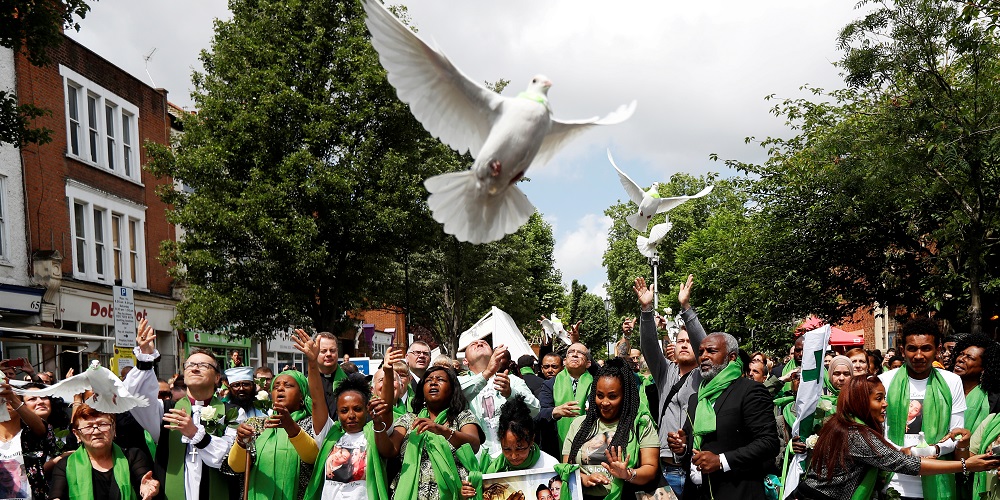 Doves are released during commemorations to mark the first anniversary of the Grenfell Tower fire, near the burn out social housing apartment block in west London, Britain June 14, 2018. REUTERS/Peter Nicholls    