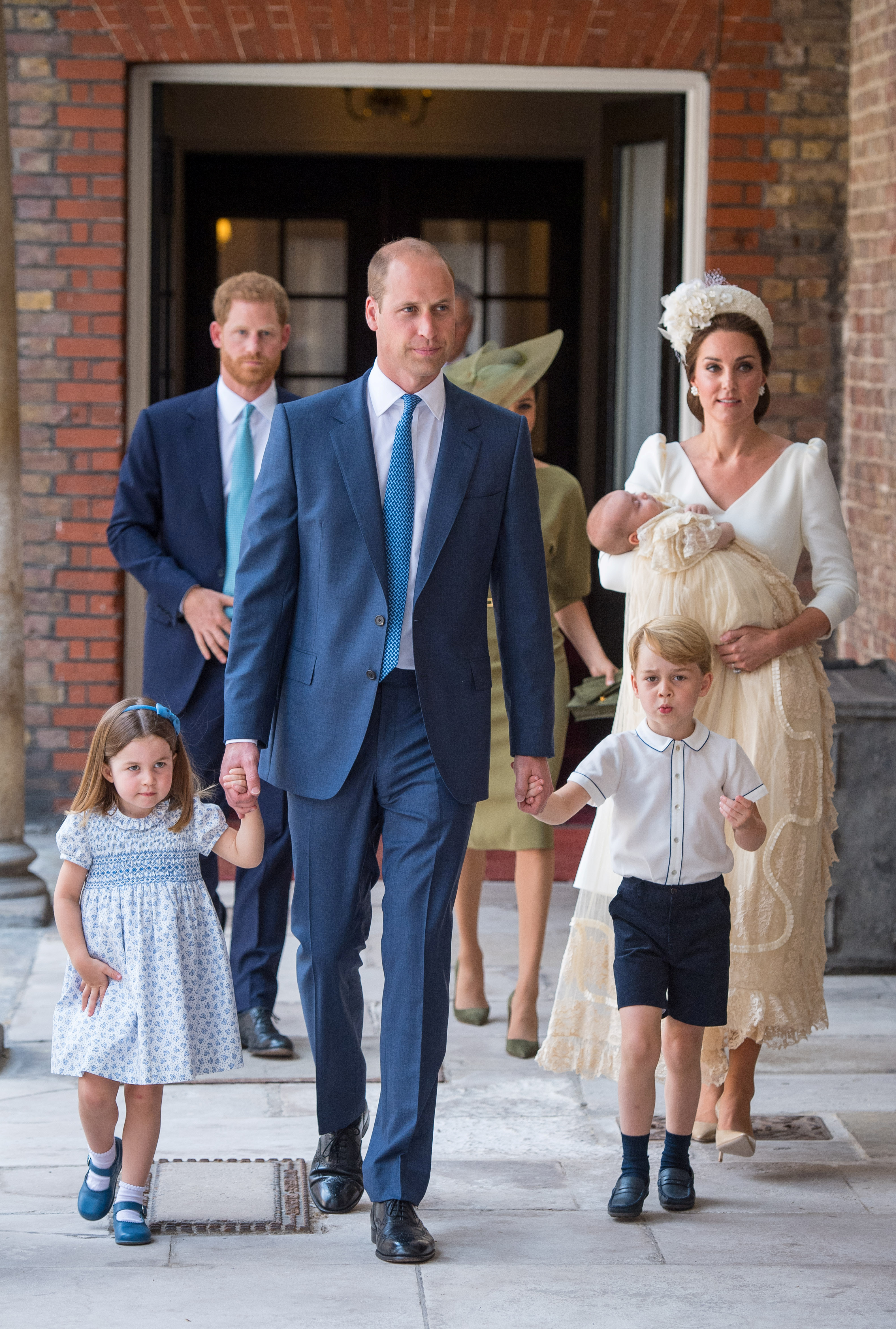 Britain's Princess Charlotte and Prince George hold the hands of their father, William, the Duke of Cambridge, as they arrive for the christening of their brother, Prince Louis, who is being carried by their mother, Catherine, the Duchess of Cambridge, at the Chapel Royal, St James's Palace, London, Britain, July 9, 2018. Dominic Lipinski/Pool via REUTERS - RC1DE7ED1E70