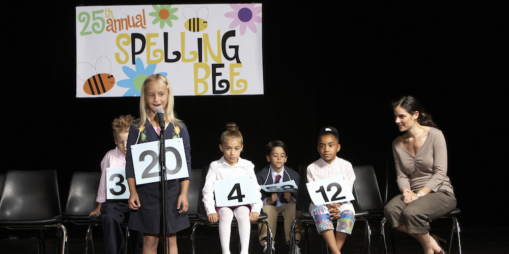 Girl (6-7) performing at spelling bee competition