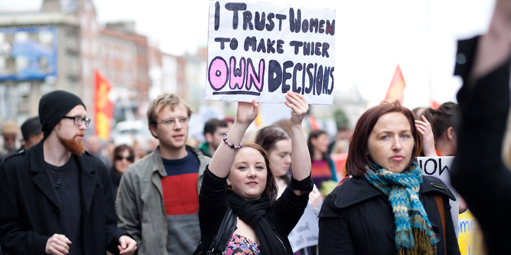 Dublin, Ireland - September 29, 2012: Dublin March for Choice 2012, Young woman holds hand made poster in act of support other women about their decisions regarding abortion
