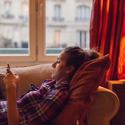 Relaxed woman at home text messaging