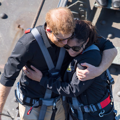 Britain's Prince Harry, the Duke of Sussex hugs a fellow climber during a visit to the Sydney Harbour Bridge with Prime Minister of Australia Scott Morrison and Invictus Games competitors on the fourth day of the Duke and Duchess of Sussex's visit to AustraliaThursday October 18, 2018. Dominic Lipinski/Pool via REUTERS - RC14D69F84C0