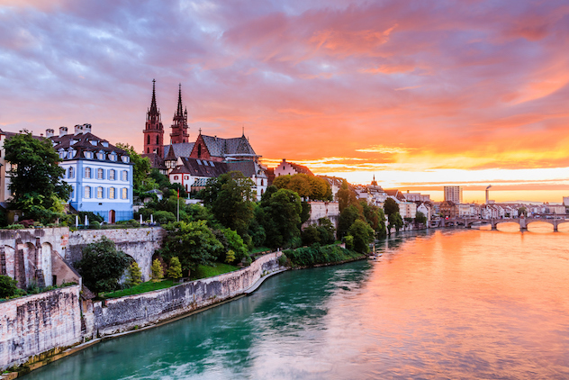 Basel, Switzerland. Old town with Munster cathedral on the Rhine river at sunset.