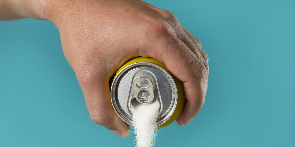 man hand holding lemon refresh drink can pouring sugar stream in sweet and calories content of soda and energy drinks concept in unhealthy nutrition and diet concept