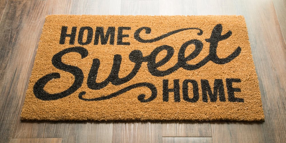 Home Sweet Home Welcome Mat On Wood Floor.