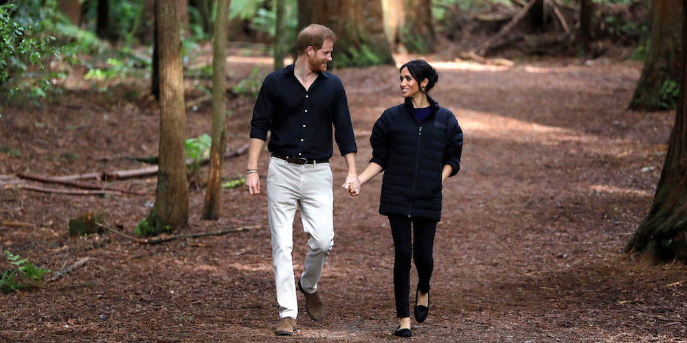 Britain's Prince Harry and Meghan, Duchess of Sussex walk through a Redwoods forest in Rotorua, New Zealand, Wednesday, Oct. 31, 2018. Kirsty Wigglesworth/Pool via REUTERS - RC11BA67A8F0