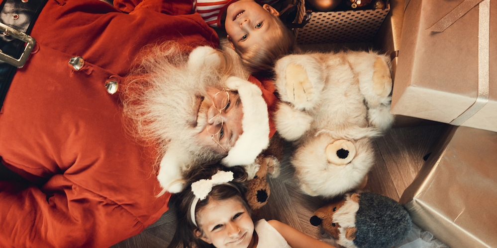 Kids and Santa lie on the floor