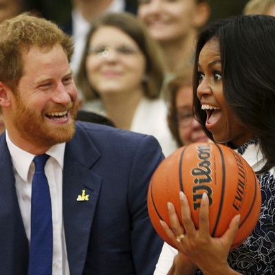 Britain's Prince Harry hands U.S. first lady Michelle Obama the basketball at the end of a game played by wounded warriors at Fort Belvoir, Virginia October 28, 2015. Prince Harry is at Fort Belvoir to meet soldiers and spread the word about the Invictus Games, which supports wounded warriors. Prince Harry spearheaded the Invictus Games, which was first held in London last September. The next Invictus Games is planned for May in Orlando, Florida. REUTERS/Kevin Lamarque  - GF20000036537