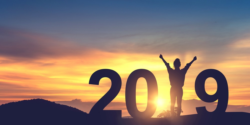 Silhouette young woman enjoying on the hill and 2019 years while celebrating new year