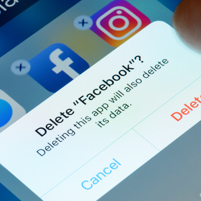 Antibes, France - February 21, 2018: User deletes Facebook app from iPhone. The social media platform faces increased scrutiny around personal data privacy and its handing of fake news and extremist content.